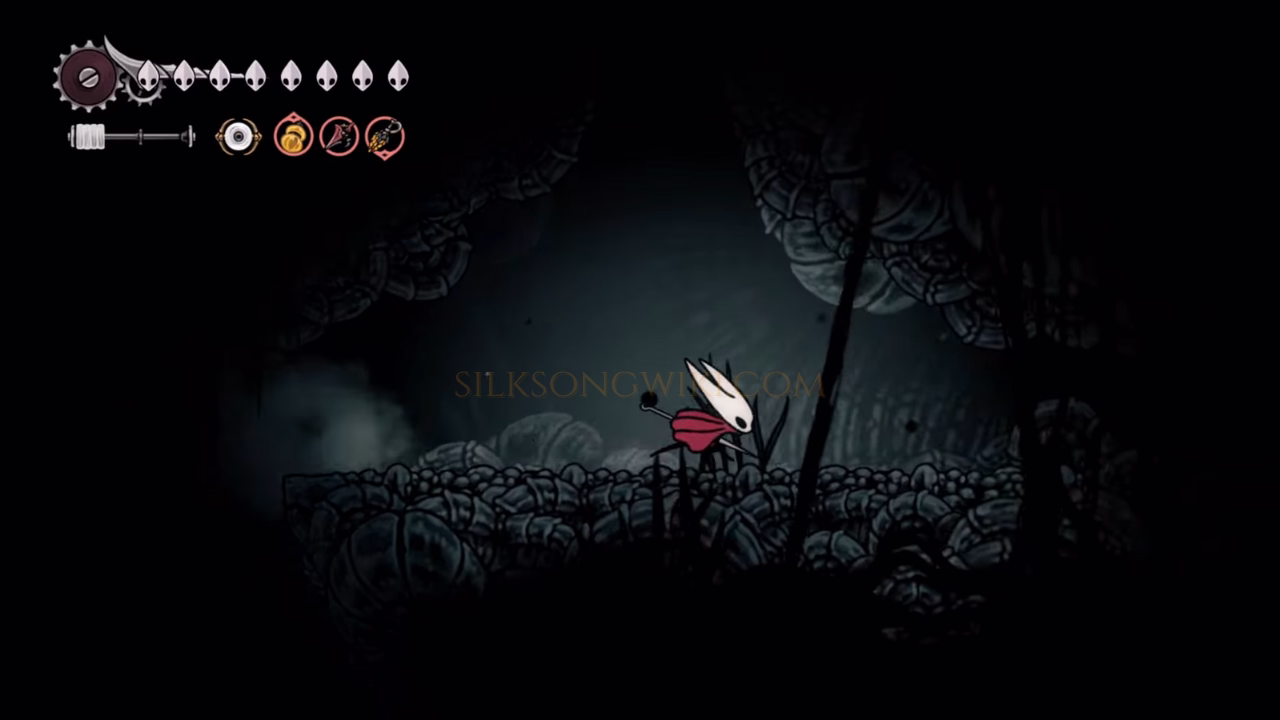Hornet fighting shadowy creatures as she moves right through a cavern in the Abyss.