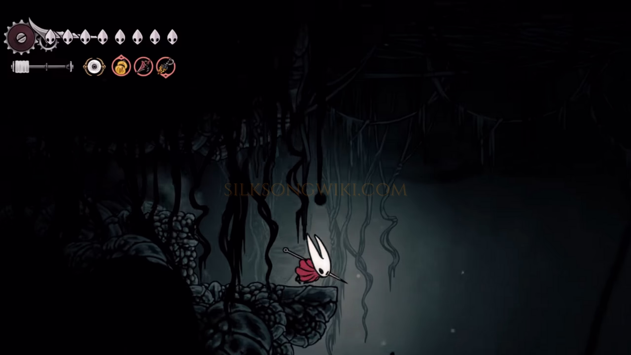 Hornet poised at the edge of a massive, dark pit inside the Abyss.